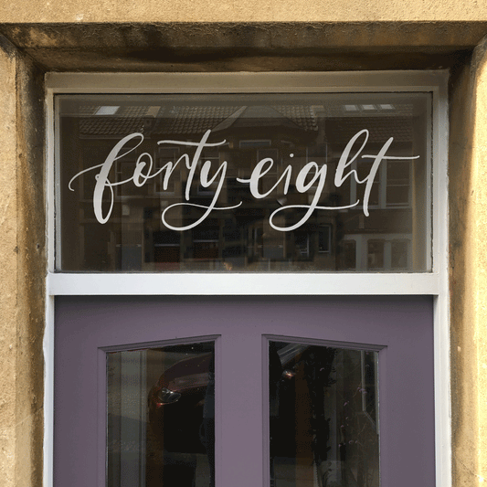 Hand-lettered custom door number window film